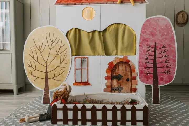 A cozy indoor puppet theater setup with hand-painted elements and whimsical decor.