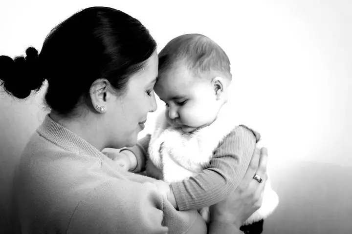 Capturing a touching moment between a mother and baby, portraying love and connection.