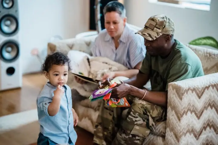 A playful moment at home showing a toddler with parents, capturing family bonding.