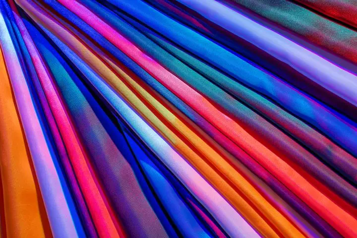Bright and colorful satin fabric layered to create a vibrant and luxurious abstract background.