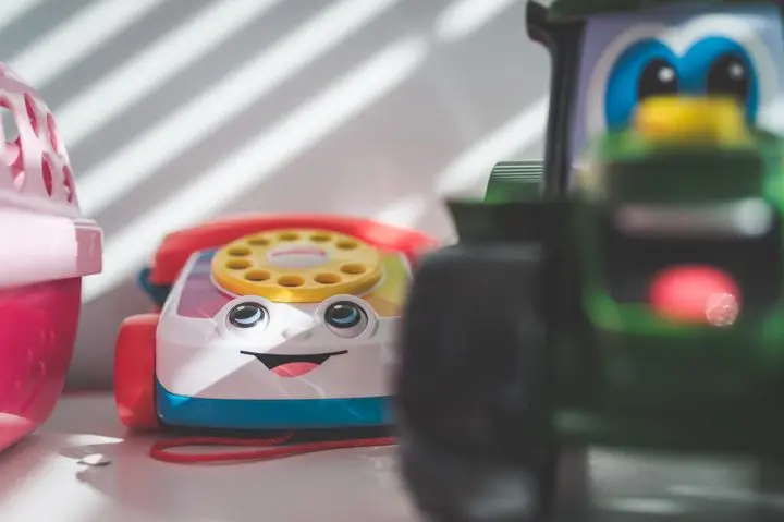 Vibrant close-up of a plastic toy telephone with selective focus on a sunny day.